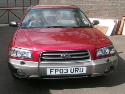 A red Subaru Forester X estate car