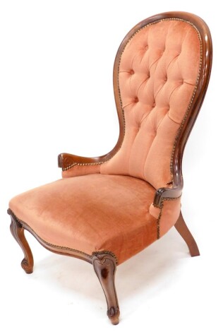 A stained beech nursing chair in Victorian style, with a button padded back, padded seat on cabriole legs. The upholstery in this lot does not comply with the 1988 (Fire & Fire Furnishing) Regulations, unless sold to a known exporter or upholsterer it wil