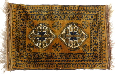 An Afghan rug, with a design of two medallions, on a brown ground, 60cm x 94cm.