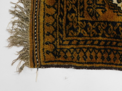 An Afghan rug, with a design of two medallions, on a brown ground, 60cm x 94cm. - 2