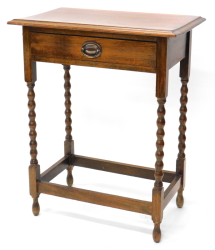 An oak side table, the top with a moulded edge, above a frieze drawer, on bobbin turned legs, 61cm wide.