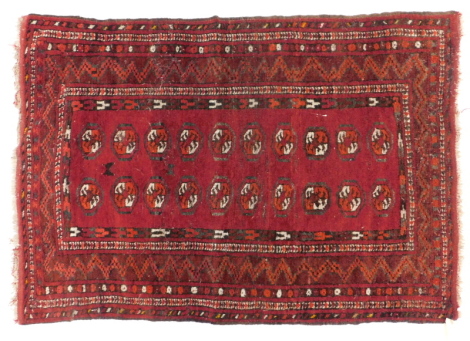 A Turkoman type rug, with a design of two rows of medallions, on a red ground, 95cm x 133cm.