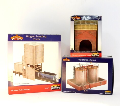 A Bachmann Scenecraft Red Brick Water Tower, Wagon Loading Tower, and Fuel Storage Tanks, all boxed. (3)