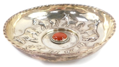 An Edward VII silver dish, embossed with a repeating pattern of six bulls, centred around a red hard stone cabochon, George Nathan and Ridley Hayes, Chester 1907, 5.44oz. - 2