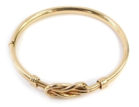 A hinged bangle, with two plait design central panel with three row bordering, yellow metal, stamped 375, 6.5cm wide, 12.6g all in.