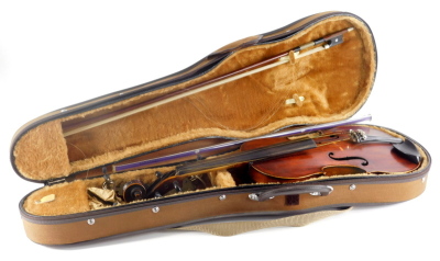 A violin, of plain form with one piece back, printed label to interior, Medio-Fino, length of back 35.5cm, sold with a bow, with nickel plated mounts, cased, etc.