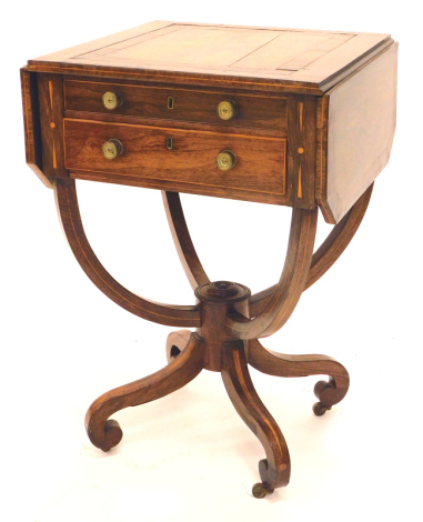 A Regency rosewood work table, the rectangular crossbanded top drop leaf top with canted corners above two drawers, each with brass handles on U shaped supports, with central column and inlaid splayed legs, with brass castors, 70cm high, 185cm wide, 45.5c