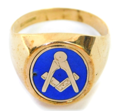 A 9ct gold Masonic gentleman's signet ring, the oval panel set with blue enamelling and Masonic symbol (AF) with reeded interior and a back crest bearing initials MV, ring size N, 5.2g all in.