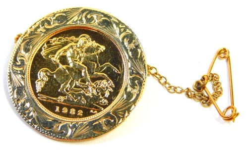 An Elizabeth II gold half sovereign, dated 1982, in a 9ct gold floral brooch frame, with pin back and safety chain, 6.1g all in.