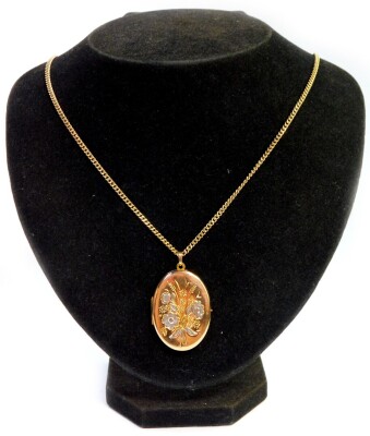 A 9ct gold oval portrait locket, with hammered floral decoration, on a 9ct gold curb link chain, the locket 3.5cm high, the chain 52cm long, 15.8g all in.