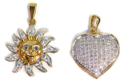 Two 9ct gold pendants, comprising a heart shaped pave set pendant, set with various imitation diamonds, 2.5cm wide, and a 9ct gold sun pendant, set with imitation diamonds and blue paste stone eyes, 3cm wide, 13.2g all in.