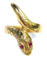 A 9ct gold snake ring, the ring head formed as head and tail of the snake set with two garnet eyes, ring size N½, 5.4g all in, boxed.