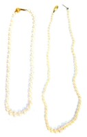 Two single strand cultured pearl necklaces, comprising one with larger cultured pearls, with a 9ct gold ball clasp, the pearl string 37cm long,together with another single strand cultured pearl necklace, with central large bead followed by smaller beads w