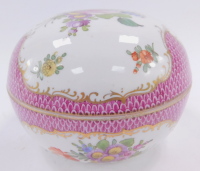 A Dresden 20thC porcelain box and cover, of cylindrical form, decorated with floral sprays and sprigs against a scale ground, gilt heightened, No 4592, painted marks, 12cm wide.