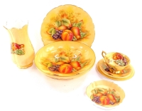 A group of Aynsley porcelain decorated in the Orchard Gold pattern, including a fruit bowl, fluted plate, teacup and saucer and a fluted and moulded vase. (8)