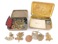 A WWI Princess Mary brass Christmas tin 1914, containing a bullet form pencil, led shot and a greetings card for 1915, together with a tin containing military buttons, badges, and medal ribbons.