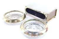 A pair of Webster sterling silver and pressed glass ash trays, stamped sterling, 10cm diameter, together with a continental rectangular match sleeve, raised on four ball feet, 12cm wide. (3)