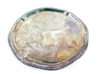 A George III silver salver, with a gadrooned rim, crest engraved, raised on three scrolling feet, makers initials I.C, London 1768, 20.5cm diameter, 11.83oz.