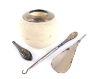 A pottery match striker, with silver mount, hallmarks worn, together with a silver handled button hook and shoe horn, hallmarks also worn. (3)