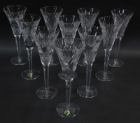 A group of ten Waterford crystal champagne flutes, decorated in Millennium Universal Wishes pattern.