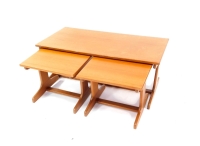 A vintage 1960s/70s teak nest of occasional tables, comprising of one long and two short inset tables, each raised on trestle end supports, largest 42.5cm high, 101cm wide, 51cm deep.