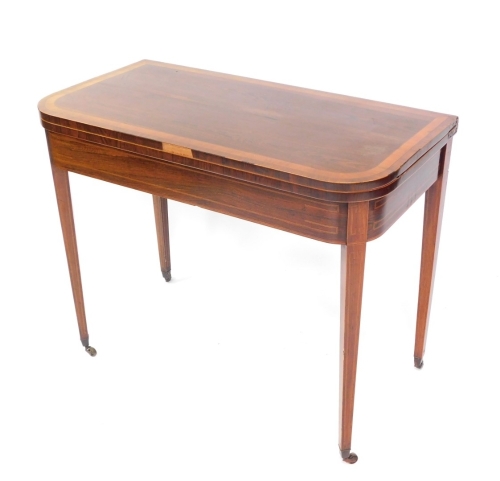 A George III rosewood and satinwood cross banded demi lune fold over card table, raised on tapering square legs, brass capped on castors, 73cm high, 91cm wide, 46.5cm deep.