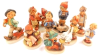 A group of Hummel pottery figures, including Strolling Along, Farm Boy, Doll Mother and Doctor. (9, AF)