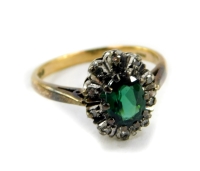 A 9ct gold and tourmaline ring, in a surround of diamonds, size L/M, 2.7g.