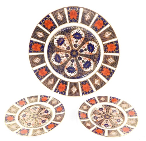 A Royal Crown Derby porcelain dinner plate decorated in the Old Imari pattern, together with a pair of tea plates, seconds, (3)