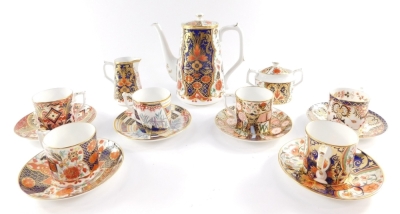 A Royal Crown Derby Imari porcelain part coffee service decorated in The Curator's pattern, comprising coffee pot, cream jug, sucrier, sixc offfee cans and saucers.