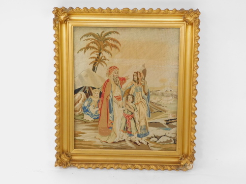 An early 19thC petit point picture, depicting figures and animals in a desert, gilt framed, 52.5cm high, 43.5cm wide.