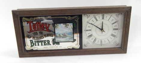 A modern Tetley Old Fashioned Flavoured Bitter advertising wall clock, of rectangular form with glazed front, Roman numeric dial, in moulded wooden case, battery powered, 55cm wide.