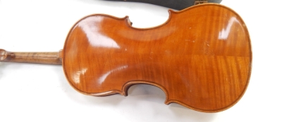 An early 20thC violin, with copy of Stradivarius, Berlin label, with two piece back, scroll end, ebonised knops and interior label, overall 59cm long. (cased, AF) - 3