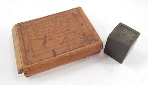 A bronze cased Eastern seal, in a block box with removable lid revealing a partially coloured seal, 5cm high, and a early 20thC box of precious religious style promises set with a quantity of paper promises, in a card outer packaging. (2)