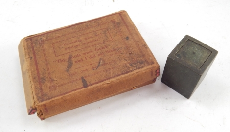 A bronze cased Eastern seal, in a block box with removable lid revealing a partially coloured seal, 5cm high, and a early 20thC box of precious religious style promises set with a quantity of paper promises, in a card outer packaging. (2)