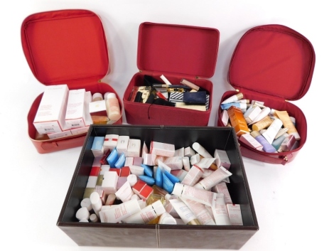 Various hair clips, Clarins Paris and others, vanity case, vinyl finish, 33cm wide, containing various other Clarins exfoliating cleanser, creams, make up, Lancome and other make up. (a quantity)