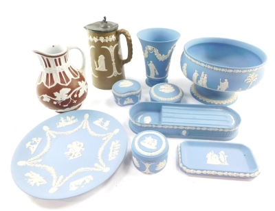 A group of Wedgwood light blue Jasper ware, including dressing table boxes and covers, pen tray, vase, plate and a fruit bowl, together with two Staffordshire late 19thC relief moulded jugs. (a quantity)