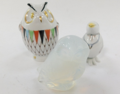 A Lalique opalescent glass figure of an owl, etched mark, together with a Meissen porcelain figure of a Doctor Bird, cross swords mark, and a Hollohaza porcelain figure of an owl. (3)