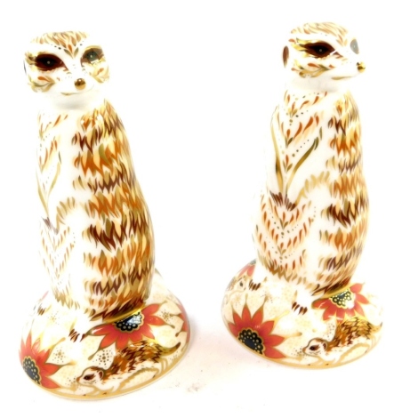 A pair of Royal Crown Derby porcelain Imari figural paperweights, modelled as meerkats, both boxed.