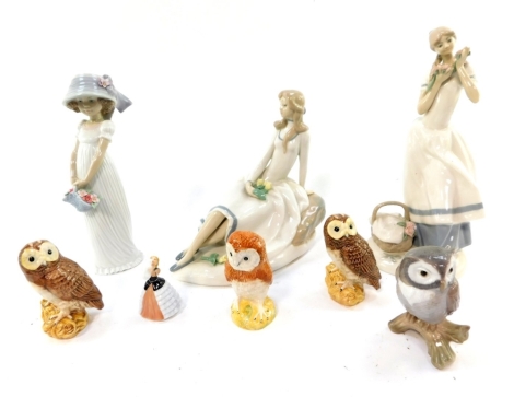 Three Beswick pottery figures modelled as owls, together with a Lladro figure of an owl, Royal Doulton figure modelled as Susan M208, and Franklin porcelain figures modelled as Teresa, The Tulip Maiden, and Cecilia The Carnation Maiden, and a Lladro porce