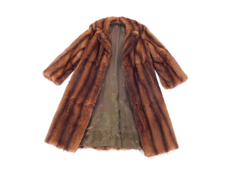 A lady's brown fur three quarter length coat.