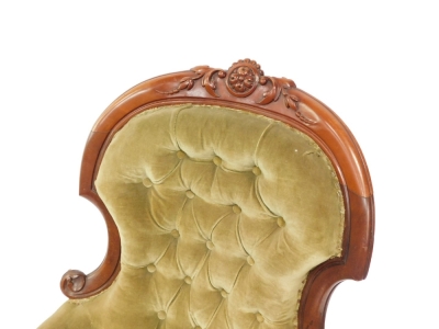A Victorian carved mahogany open spoon back armchair, with studded back, plain arms and serpentine seat, heavily carved with flowerheads and fruits to the curved top rail, with heavily carved inverted arms on triple turned legs terminating in castors, 112 - 2