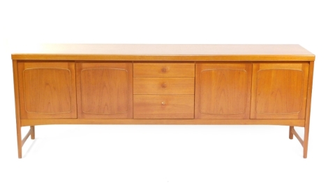 A vintage G plan teak sideboard, of rectangular form, centred by three graduated drawers flanked by four cupboards, on shaped legs joined by front to back stretchers, labelled 79cm high, 211cm wide, 46cm deep.