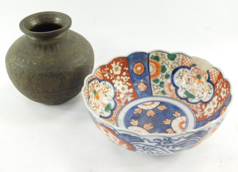 A late Meiji period Japanese Imari bowl, of shaped floral form, 22cm wide, and a brass vase of circular form raised with birds and flowers. (2)