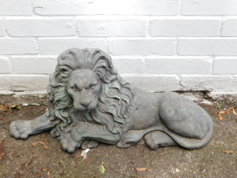 A cast concrete lion door porter, with a lead effect coating skin, 70cm wide.