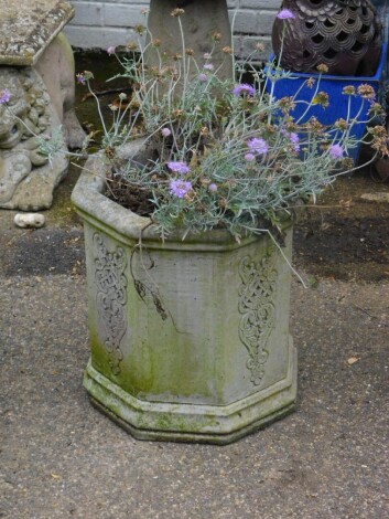 A chimney pot planter, of octagonal form, containing flowers 40cm high.