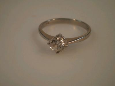 A solitaire diamond ring of 0.50cts in plain Tiffany setting to platinum shank