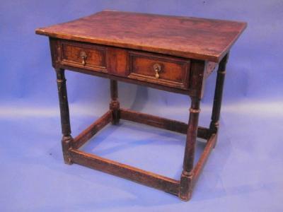 A late 17thC oak side table with three plank top over single drawer