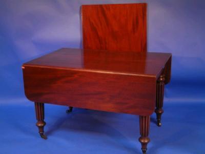 An early 19thC mahogany extending dining table with drop ends