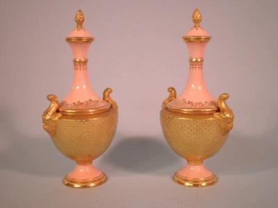 A pair of Coalport porcelain vases and covers